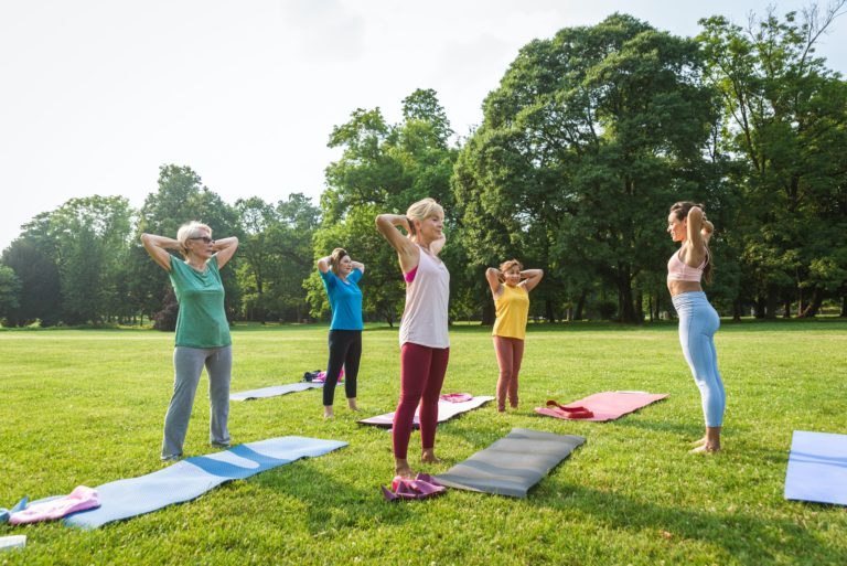 Senior women training with fitness coach at park