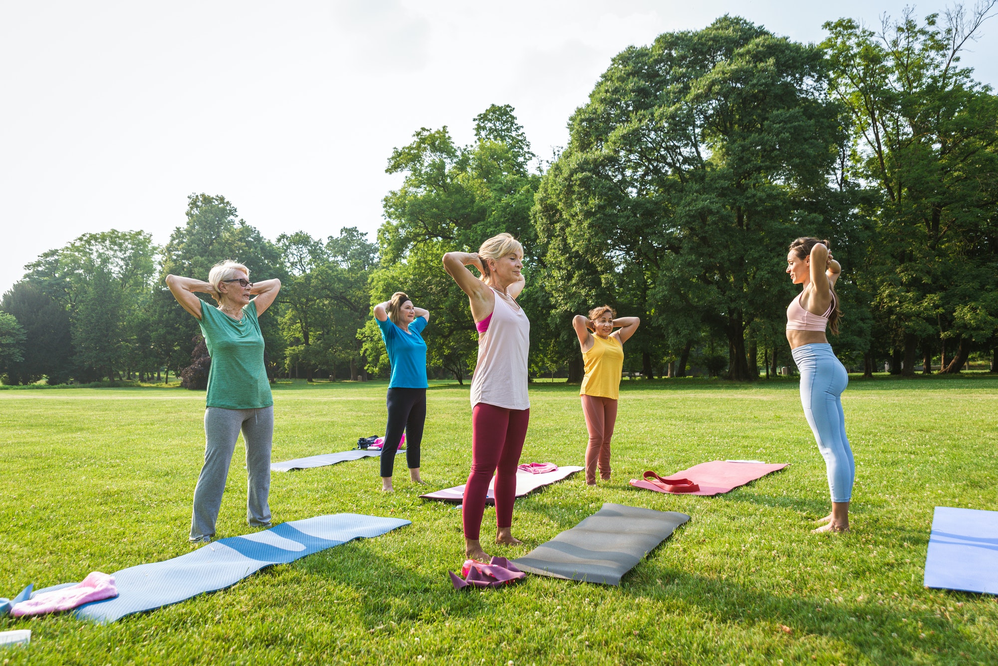 Senior women training with fitness coach at park